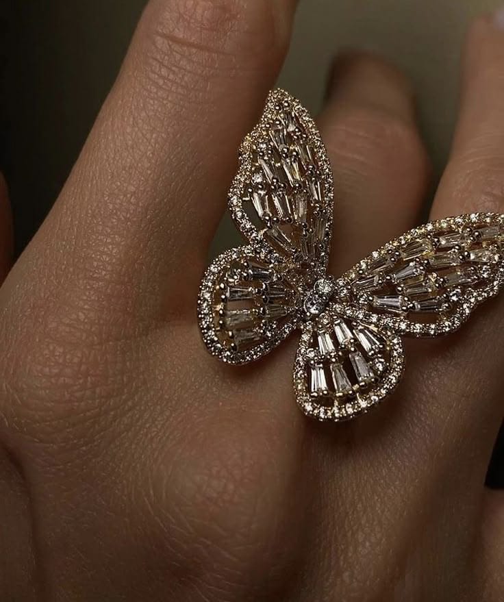 Butterfly-shaped diamond ring on a finger