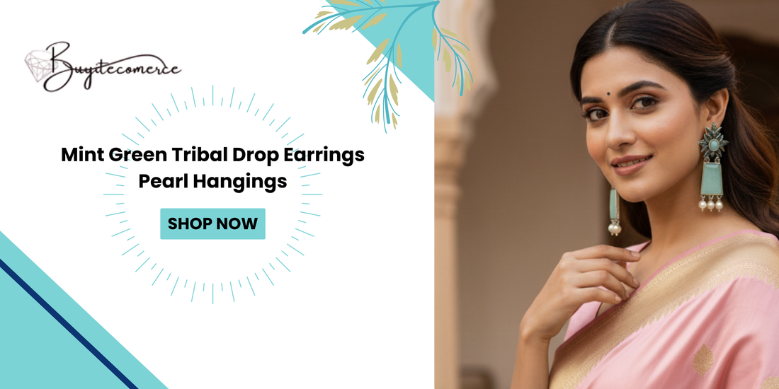 Woman wearing mint green tribal drop earrings with pearl hangings, styled with a traditional pink and gold saree