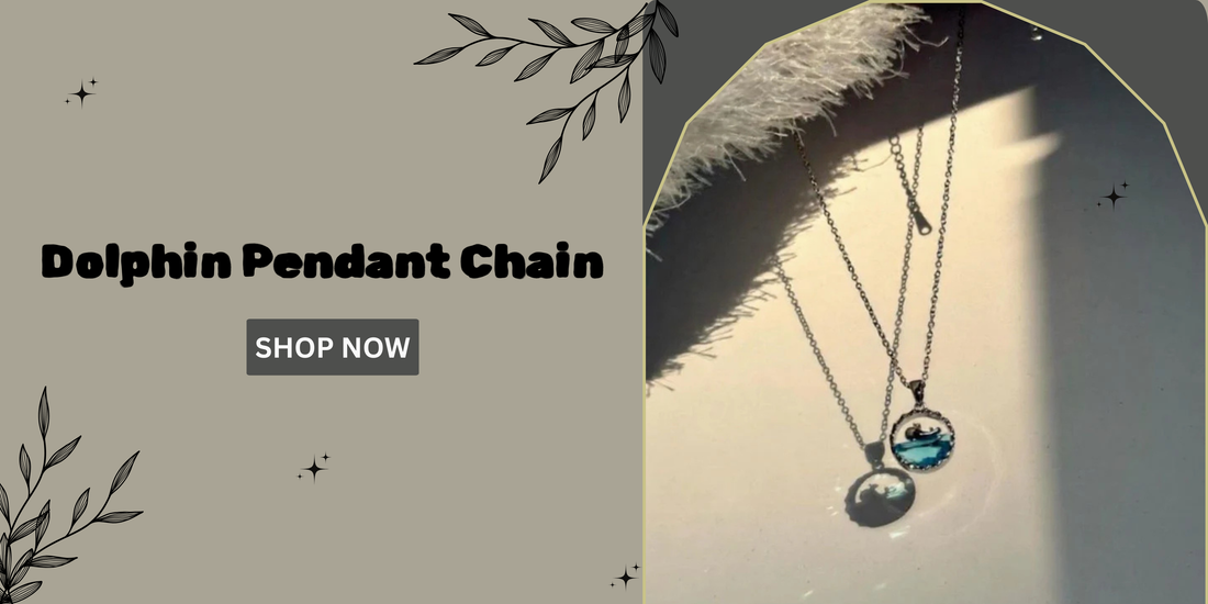 Silver dolphin pendant chain casting a shadow in natural light, displayed on a beige background with floral design elements