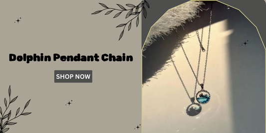 Silver dolphin pendant chain casting a shadow in natural light, displayed on a beige background with floral design elements