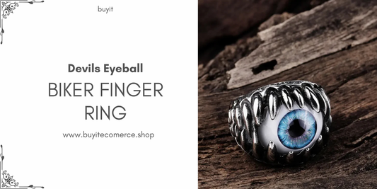 Devil’s Eyeball Biker Finger Ring in metallic design with blue eyeball centerpiece displayed on wooden surface