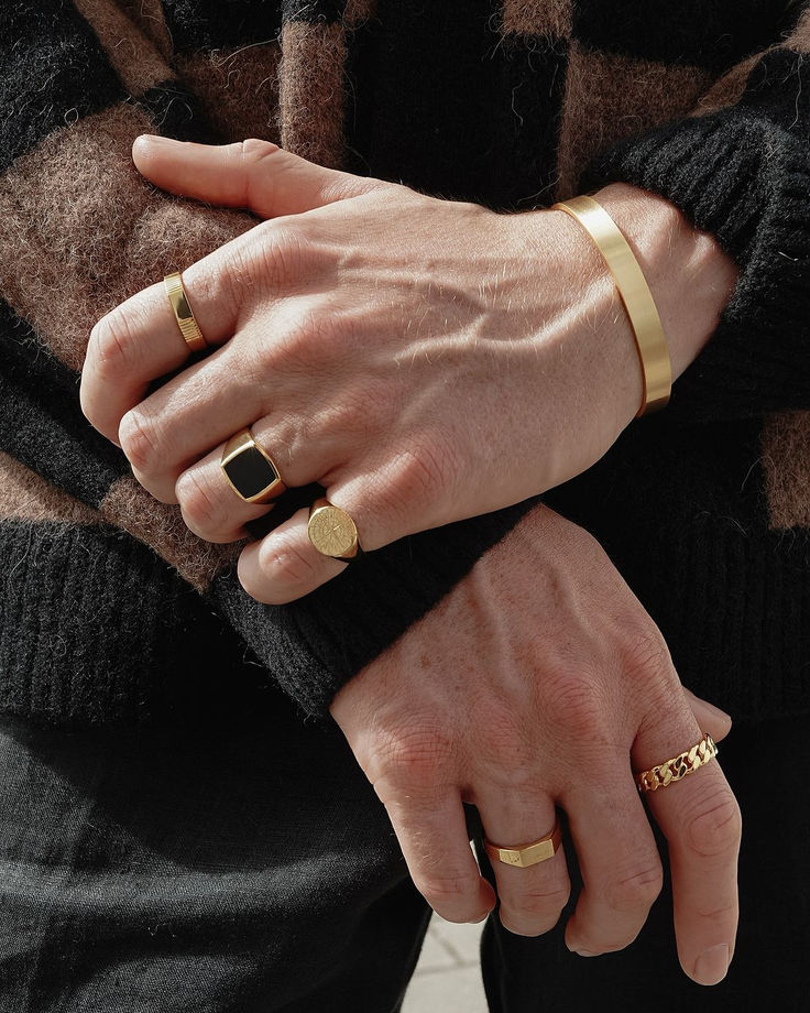 A collection of men's rings displayed on a textured surface, featuring gold, silver, and tungsten designs. Elegant bands, signet rings, and statement pieces crafted for style, durability, and everyday wear. Perfect for gifting and special occasions.