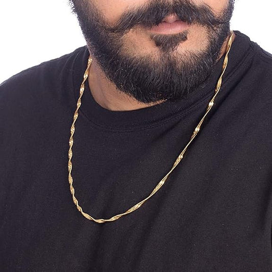 Man wearing a gold chain necklace against a white background