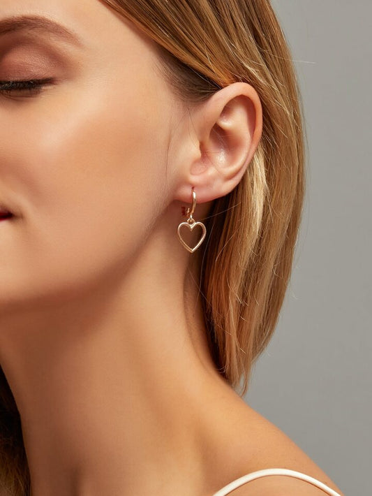 Elegant gold heart drop earring with a minimalist design, perfect for everyday wear or special occasions, showcasing a delicate heart charm hanging gracefully.