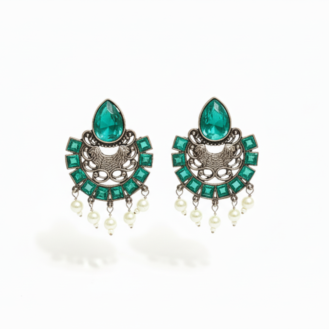 Pair of earrings with green gemstones and pearl-like elements on a white background